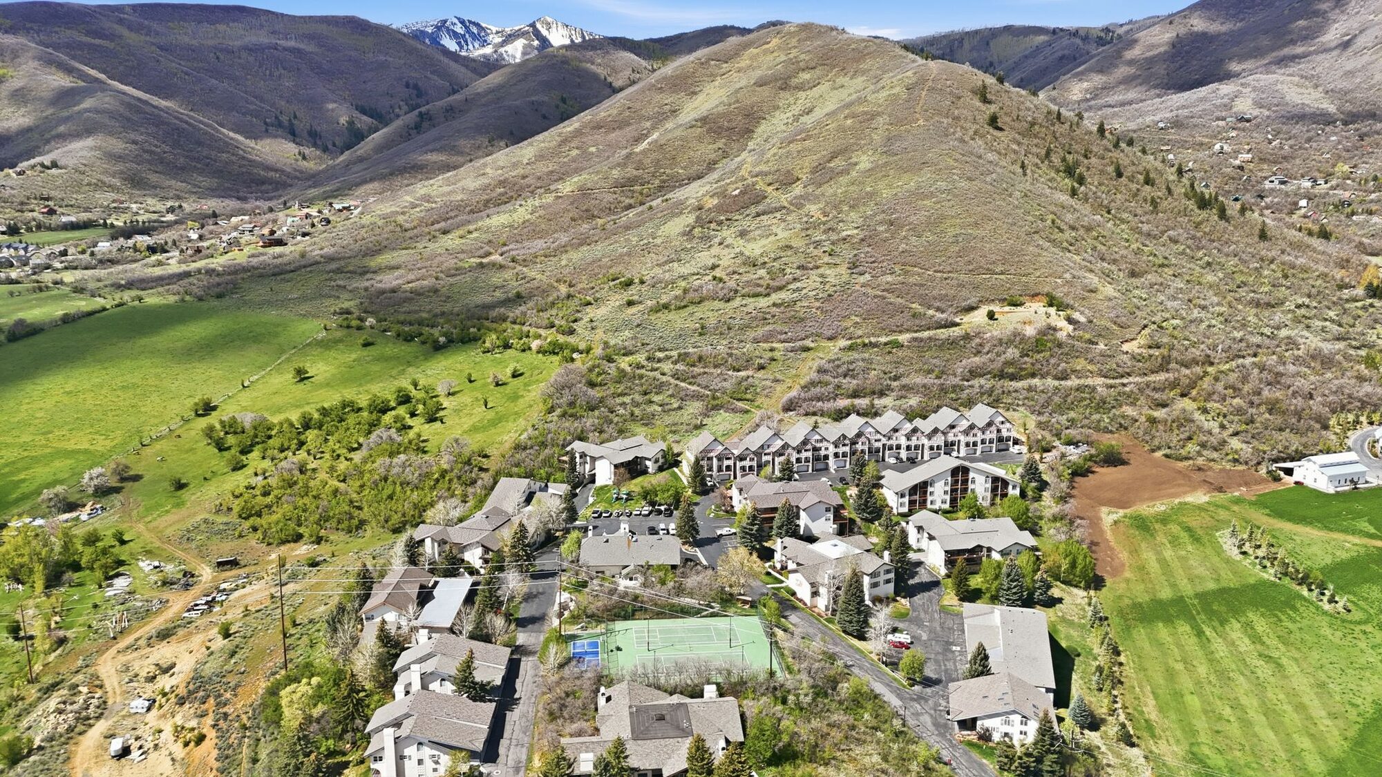 Overhead view of Swiss Oaks townhome community in Midway Utah showing clubhouse, playground, and Wasatch Back mountain backdrop