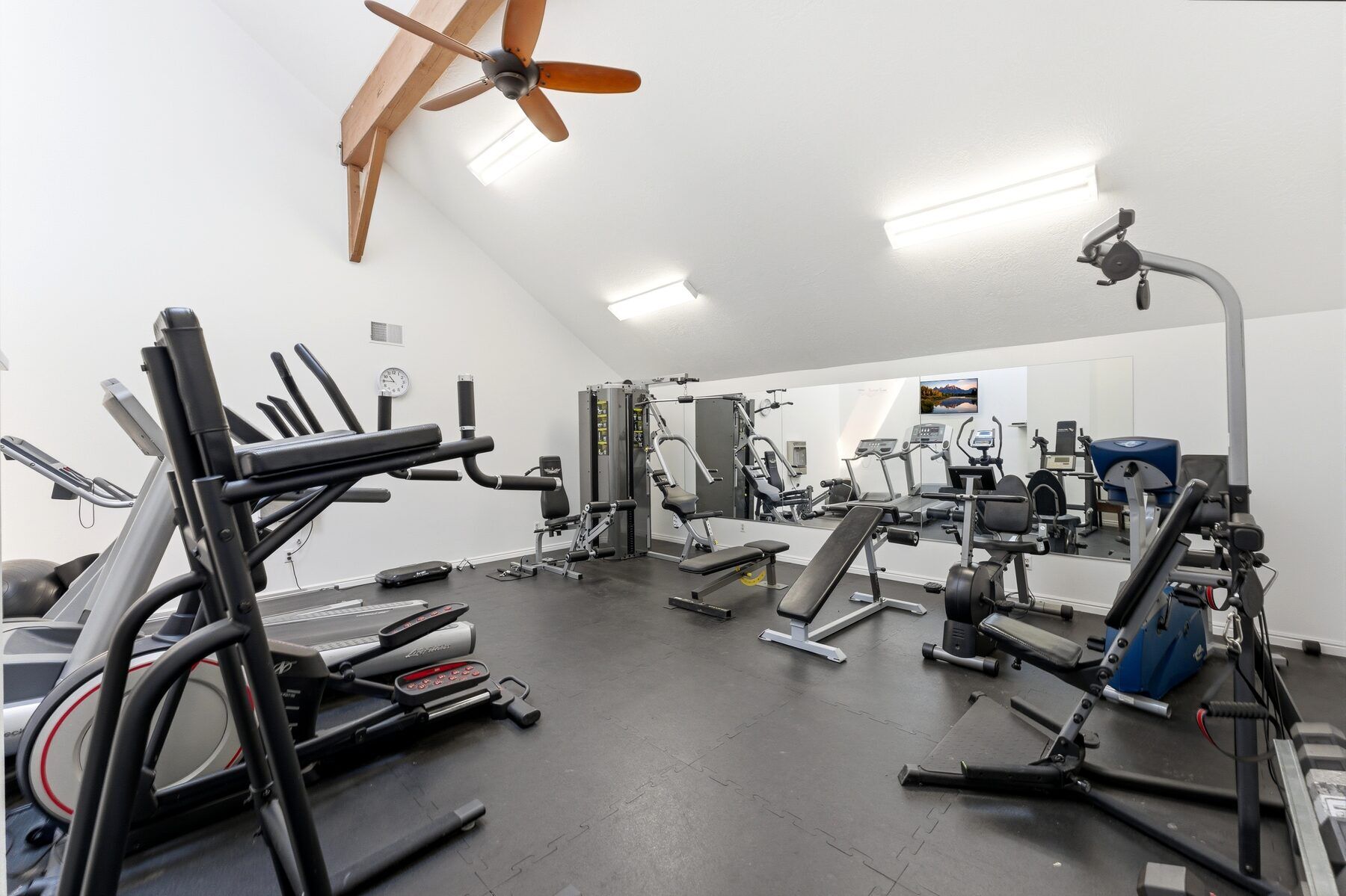 Swiss Oaks community fitness room with cardio and weights in Midway