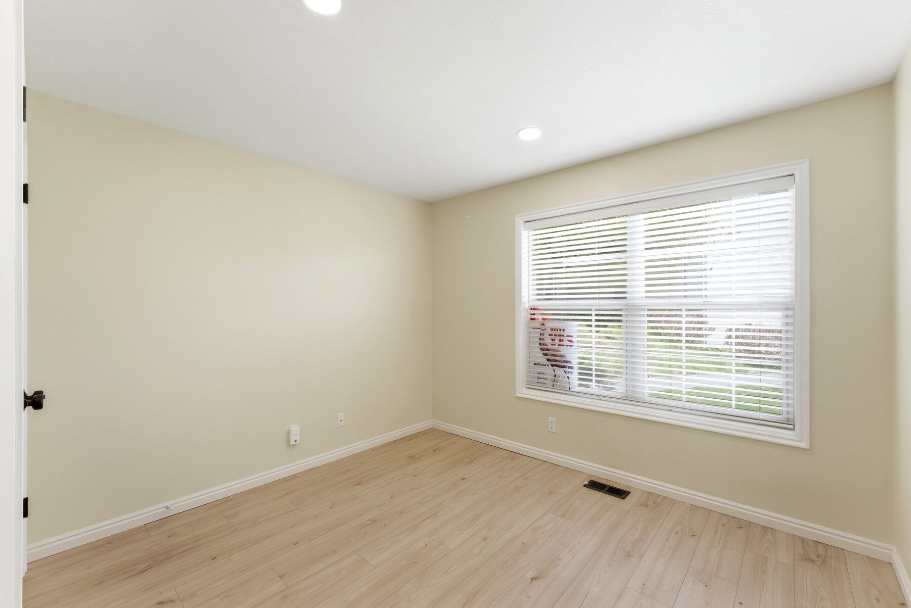 Second bedroom with window and natural light in Midway Swiss Oaks condo