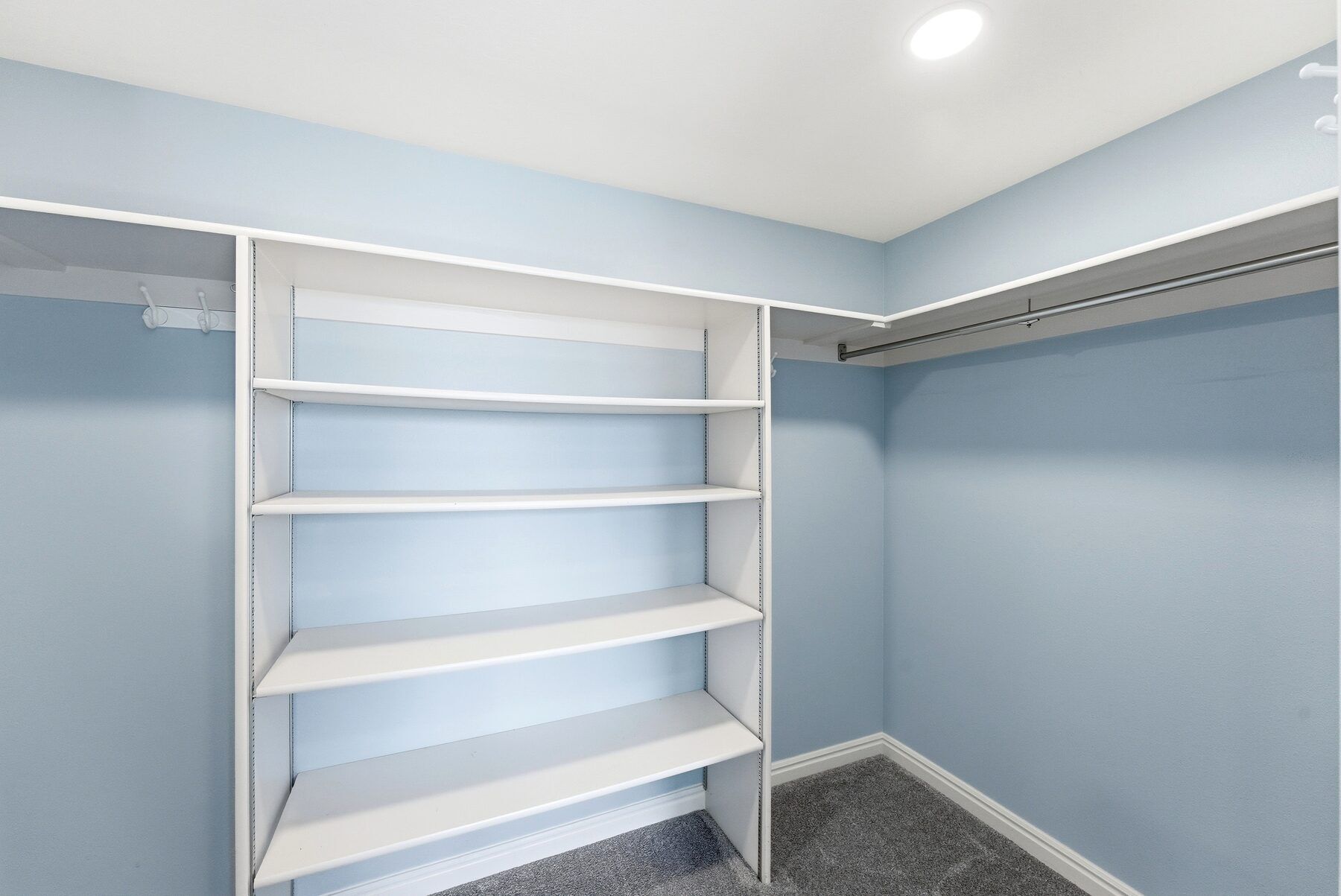 Walk-in closet with built-in shelving in Swiss Oaks Midway condo