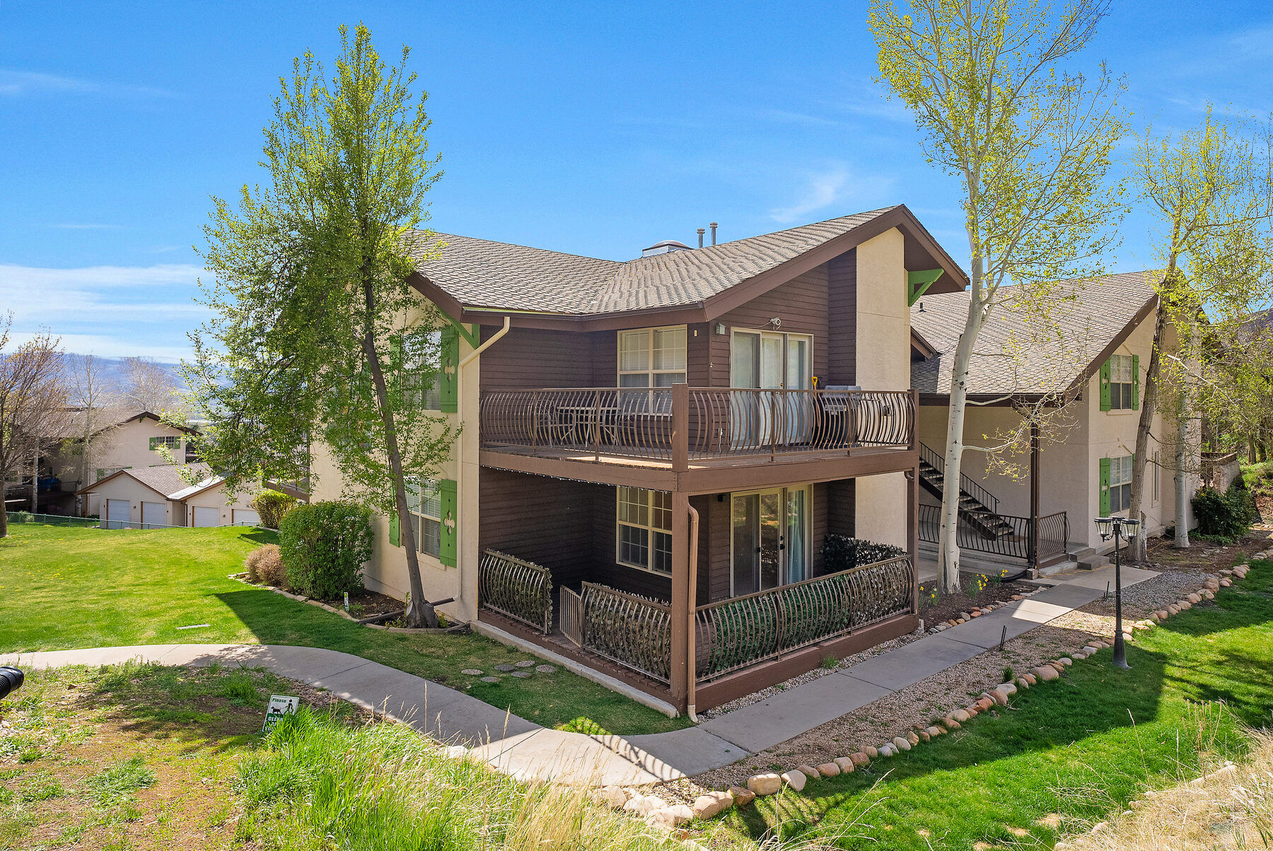 Swiss Oaks condominium building set among trees and hillside in Midway Utah