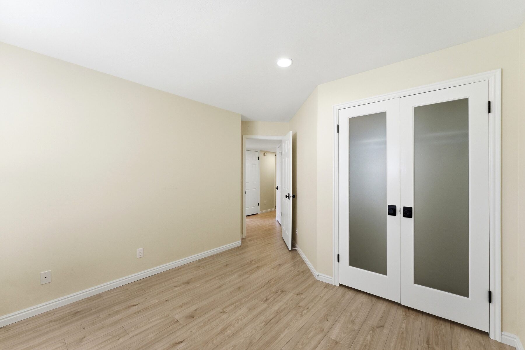 Flexible room with French doors, ideal as office or den, in Midway condo