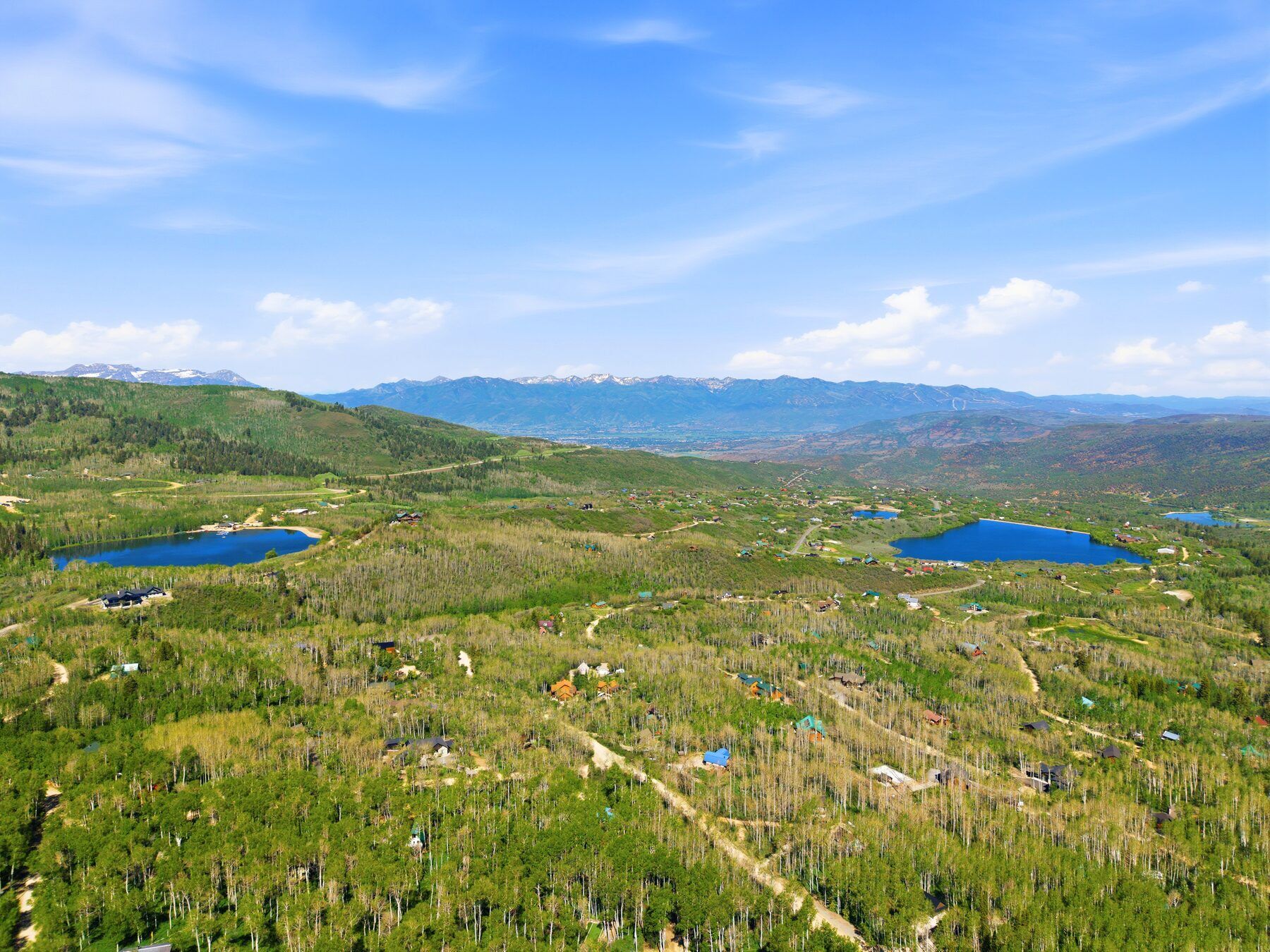Aerial view over Timber Lakes Heber City showing forest, valley, and Wasatch Back mountains