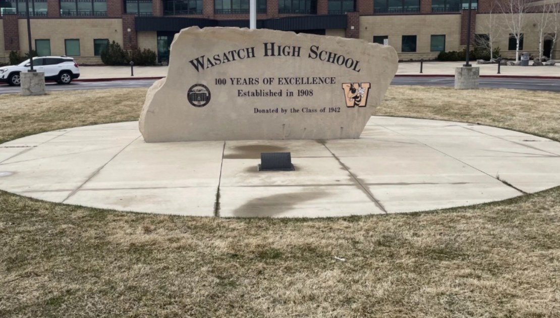 Wasatch High School entrance monument in Heber City, Utah, engraved with '100 Years of Excellence, Established in 1908'